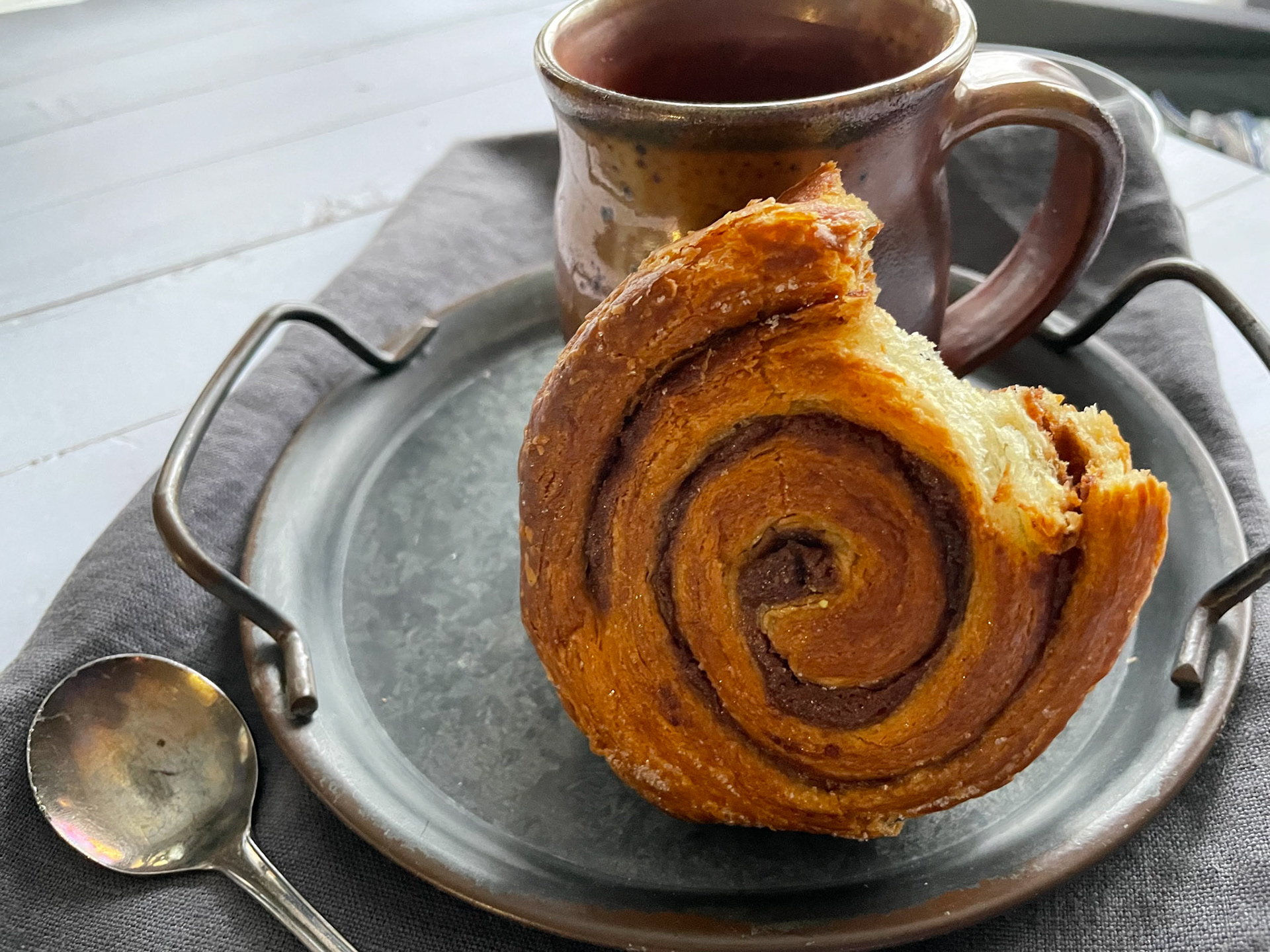 Food_handmade ceramic mug and cinnamon bun